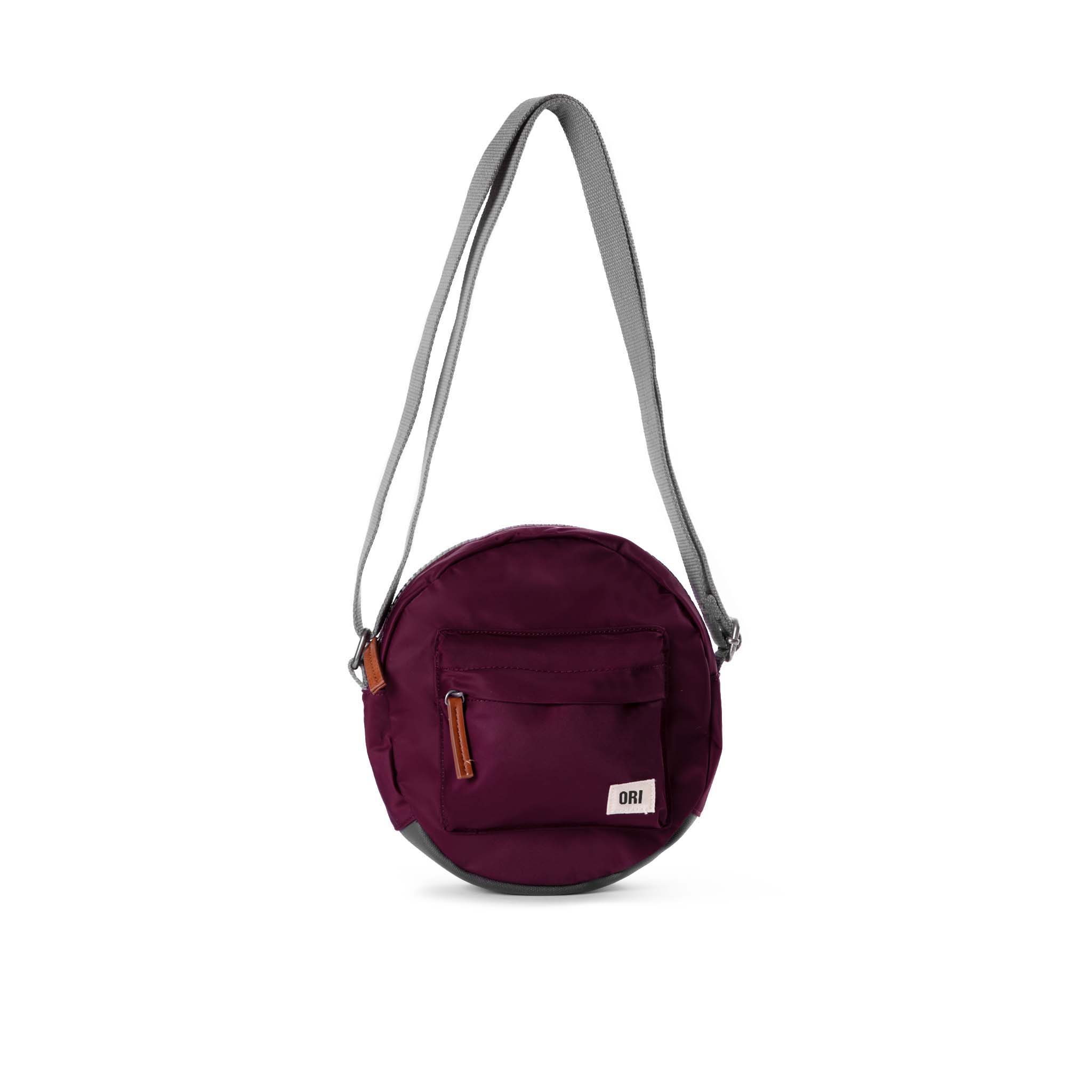 Over the shoulder and crosstown, our Paddington Crossbody is the perfect round bag to sling across your body and take on your day.

The Paddington bag has three pockets and sections to keep everything organized, safe and secure, all in weather-resistant, recycled material. color Plum
