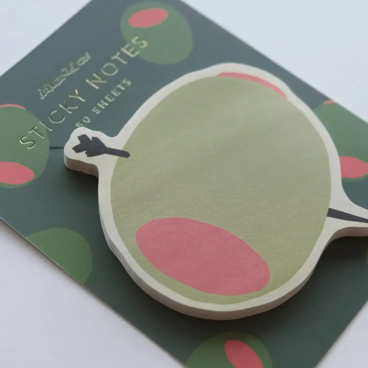 Sticky notes with a green and pink design on a matching background