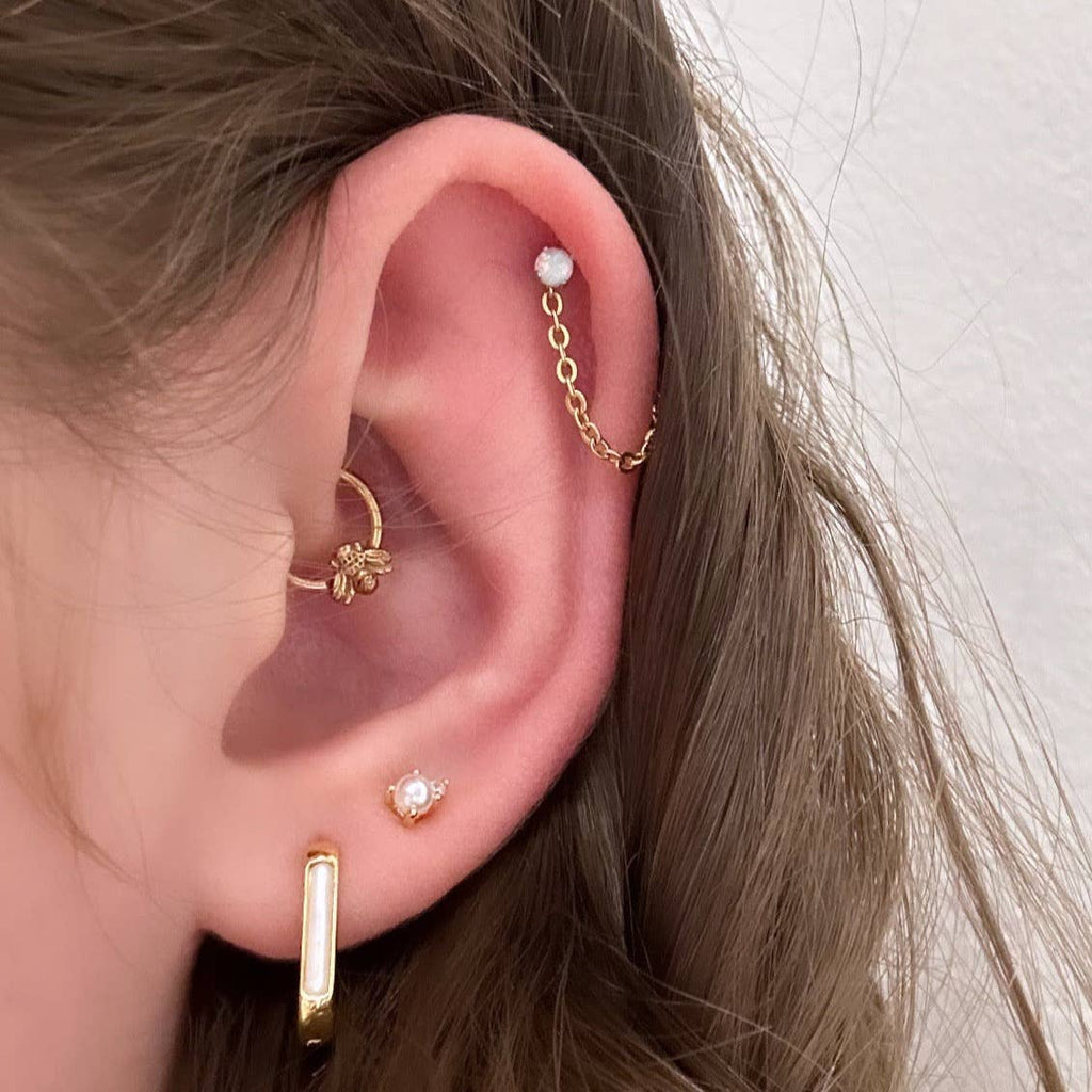 Mother of Pearl is often associated with creativity and prosperity. These unique and stylish huggie hoops are perfect for expressing your unique and creative self!

• 925 sterling silver with gold plating

• Extra layer of tarnish resistance

• Mother of Pearl Stone

• Manufactured for our curated collection.