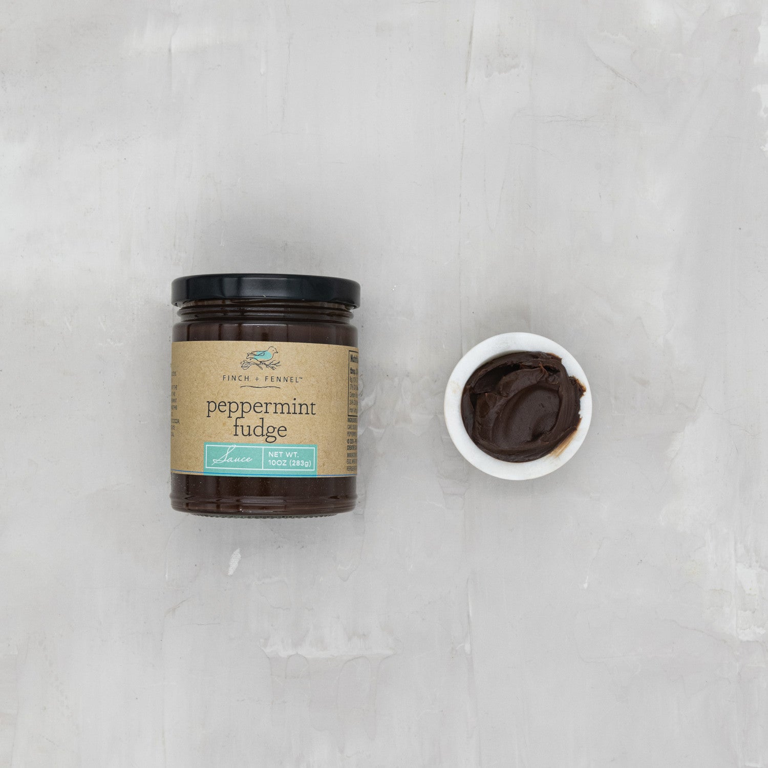 Indulge in the festive delight of our 10 oz. Peppermint Fudge Sauce. This rich, decadent hot fudge is infused with refreshing natural peppermint flavor, making it the perfect topping for ice cream, brownies, or enjoying straight from the spoon. A holiday treat you can enjoy all year!