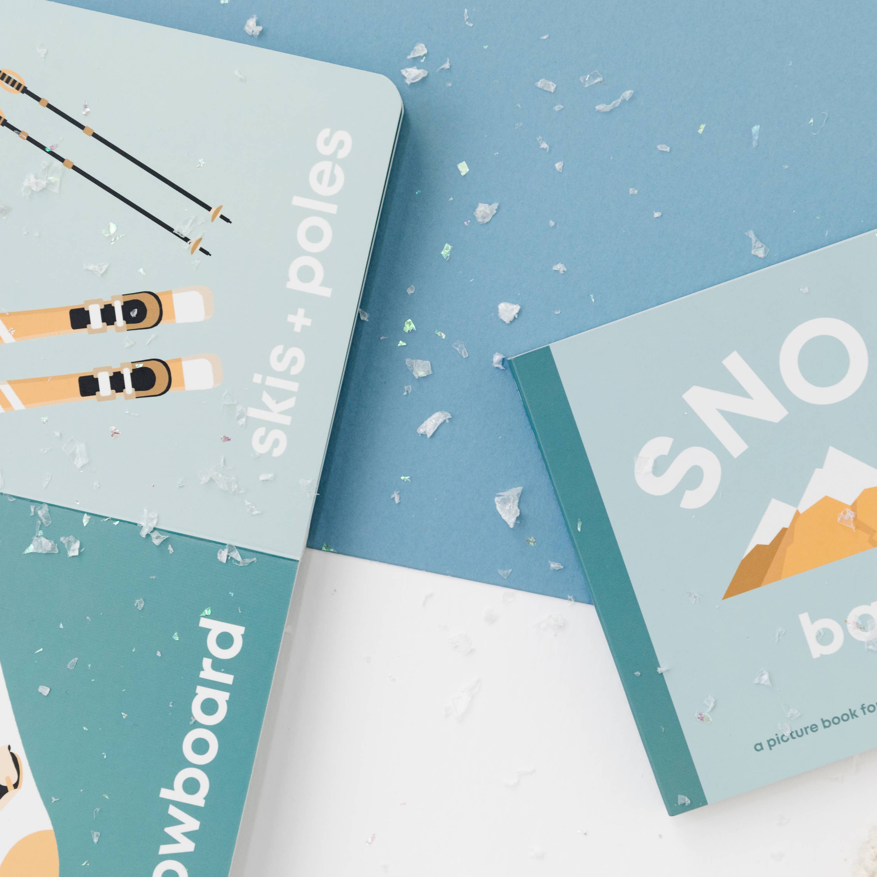 Three children's books with snow-themed illustrations on a blue and white background.