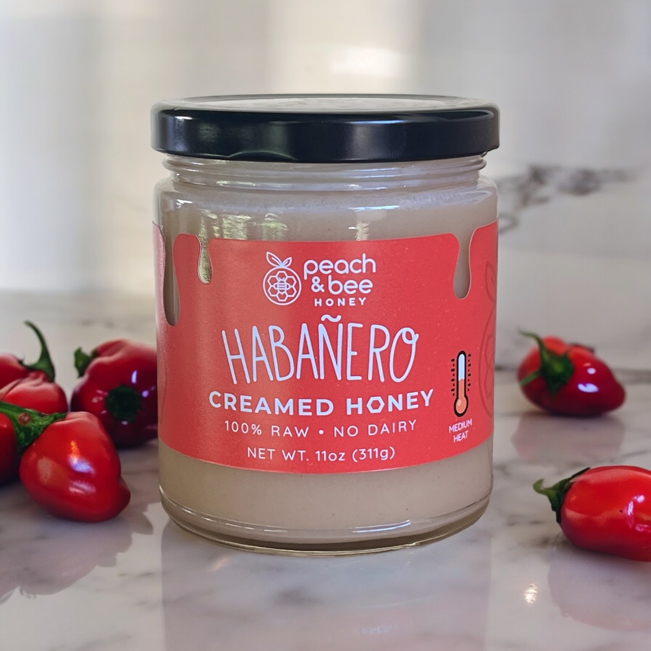 A jar of Peach & Bee creamed honey habanero flavor