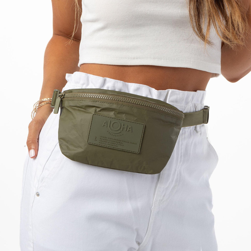 Whether you want to carry a snack, pack your phone, or speed through TSA, this olive color hip pack helps you do it all hands-free. Store your cash, credit cards, and hotel keys in a handy inside zipper pocket and easily access your ID or passport during air travel or train transit. It's great for traveling, hiking, biking, and everyday adventures. With its versatile design, you can wear it as a crossbody bag or around your waist.