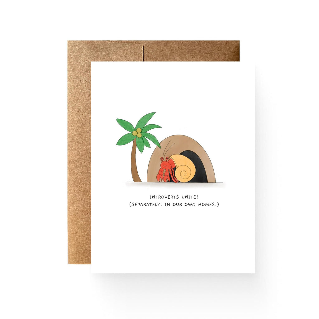 white card with a hermit crab, palm tree, and cave. reading "introverts unite! (separately, in our own homes)"