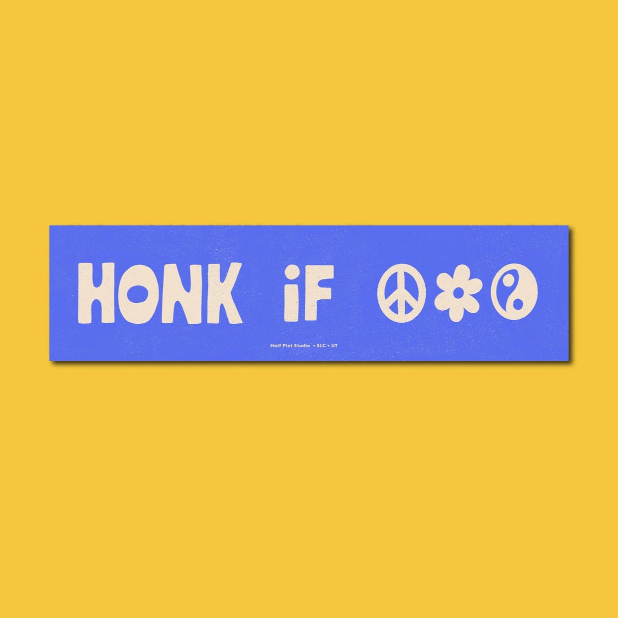 Blue bumper sticker reading "honk if" with a peace sign, flower, and yin yang symbol. 