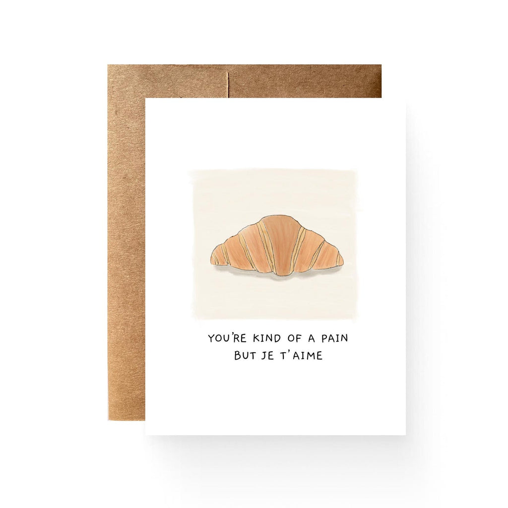 white card with an illustration of a croissant reading "you're kind of a pain be je t' aime"