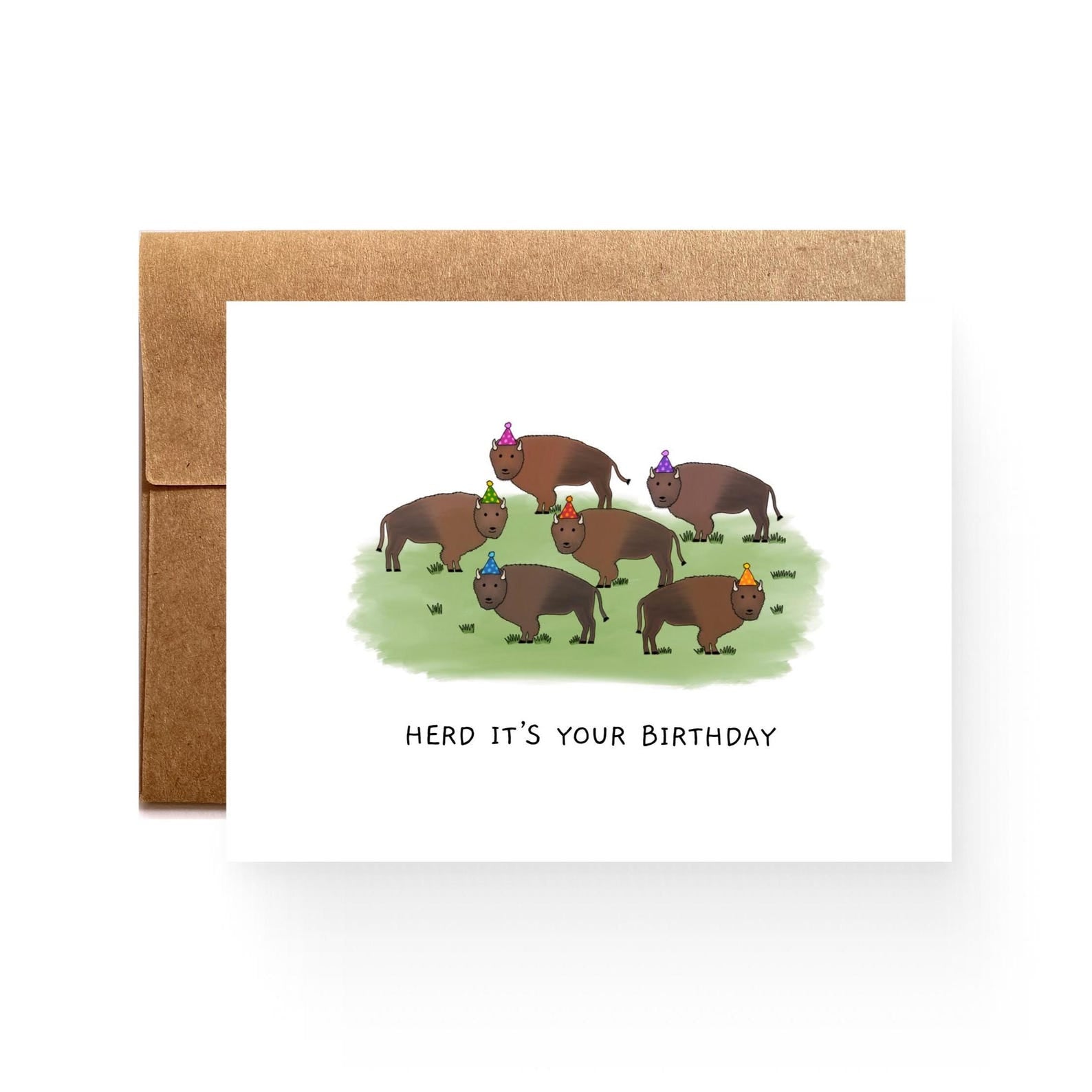 white card with a herd of bison in colorful party hats, reading "Herd it's your birthday"