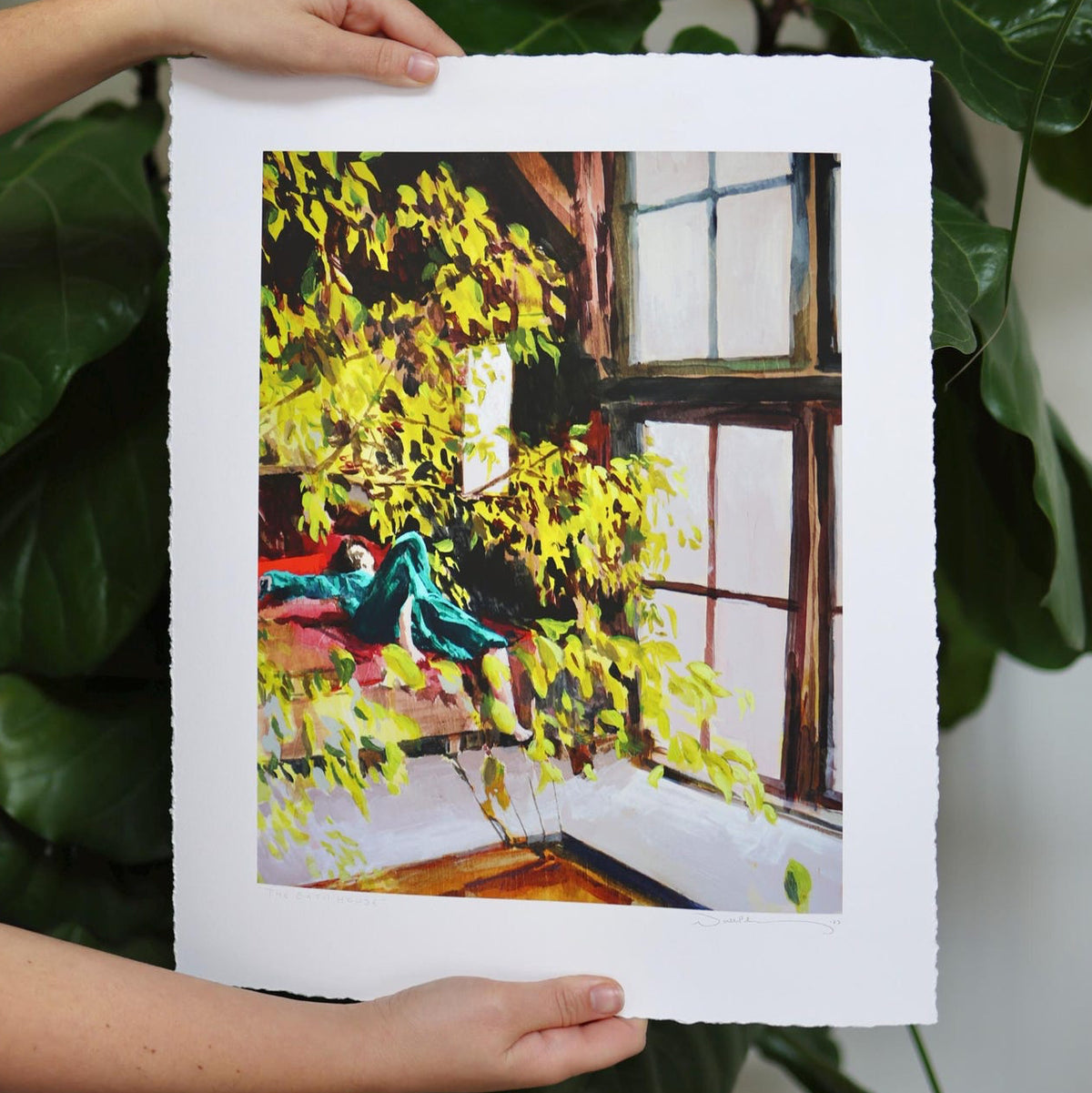 A figure lays under a green tree inside a bath house.