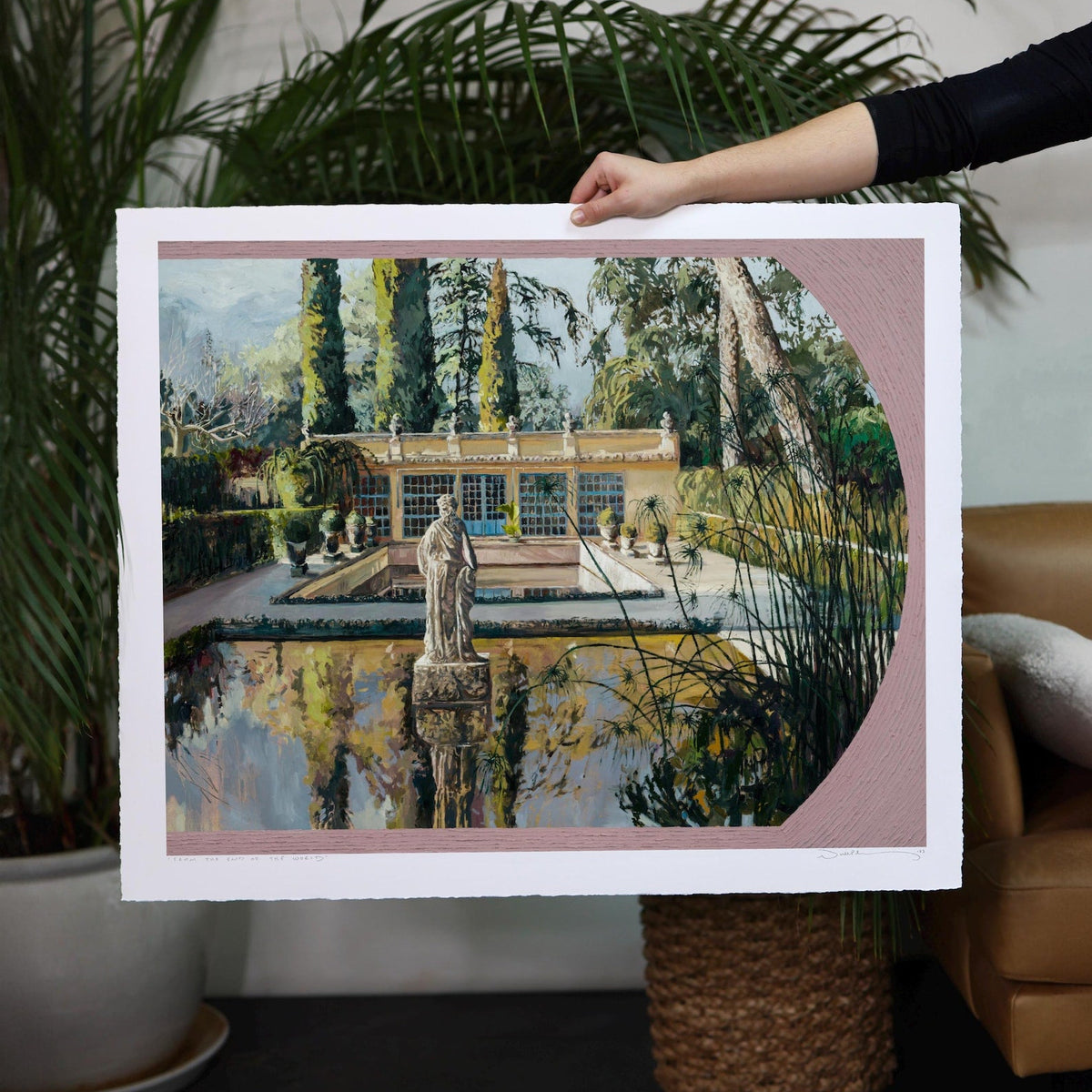 Reflective pool with statue surrounded by hedges, trees, and detailed architecture. 