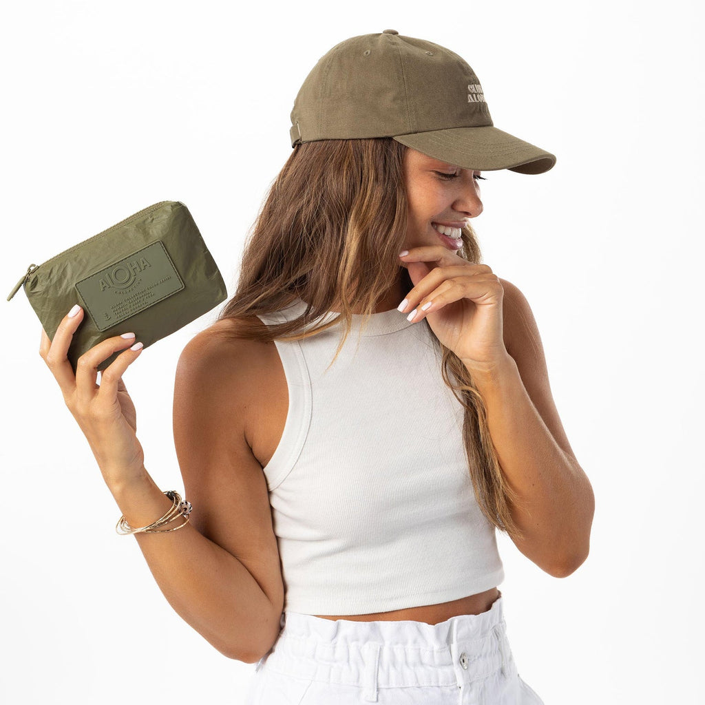 Meet the Mini pouch in Olive. Don't let its small size fool you—this pouch can be used in a million ways to keep life's little moments organized. Traveling by air? Curate your own inflight kit to keep essentials like a sleep mask, earplugs, face serum, and sanitizer spray in one convenient place. Put it to use as a coin purse or small wallet to store keys, credit cards, cash, and IDs to keep your bags clutter-free.