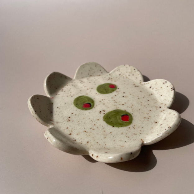small scalloped plate with 3 painted olives