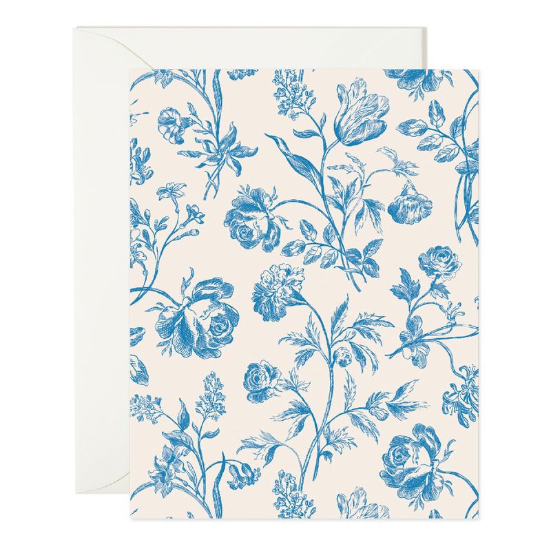 a white card featuring intricate blue florals