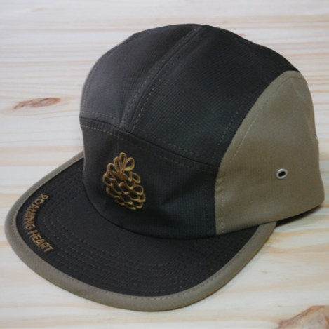 black and olive green flat brim hat with pine cone in gold/brown stitching