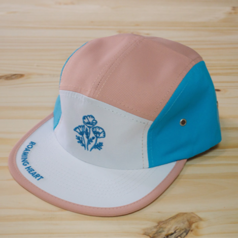 pink, blue, white flat brim hat with blue poppies stitched in the center