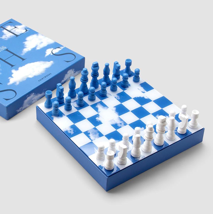 Discover our unique edition, "Chess Clouds", featuring a spectacular design inspired by the sky. The pieces and board are made of wood, with a thin layer of acrylic mounted on the board's surface, creating an impressive reflection. The box is crafted from high-quality art paper, adorned with a printed cloud formation, and enhanced with a hot foil print in navy and white.