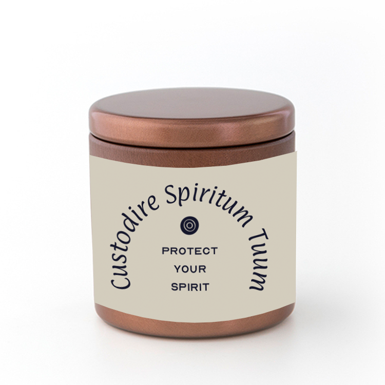 A bronze-colored travel candle with a label that reads 'CUSTODIRE SPIRITUM TUUM' which translates to 'PROTECT YOUR SPIRIT' in Latin, indicating a spiritual theme. The candle is placed in a simple beige cardboard container with a clear window displaying the candle.