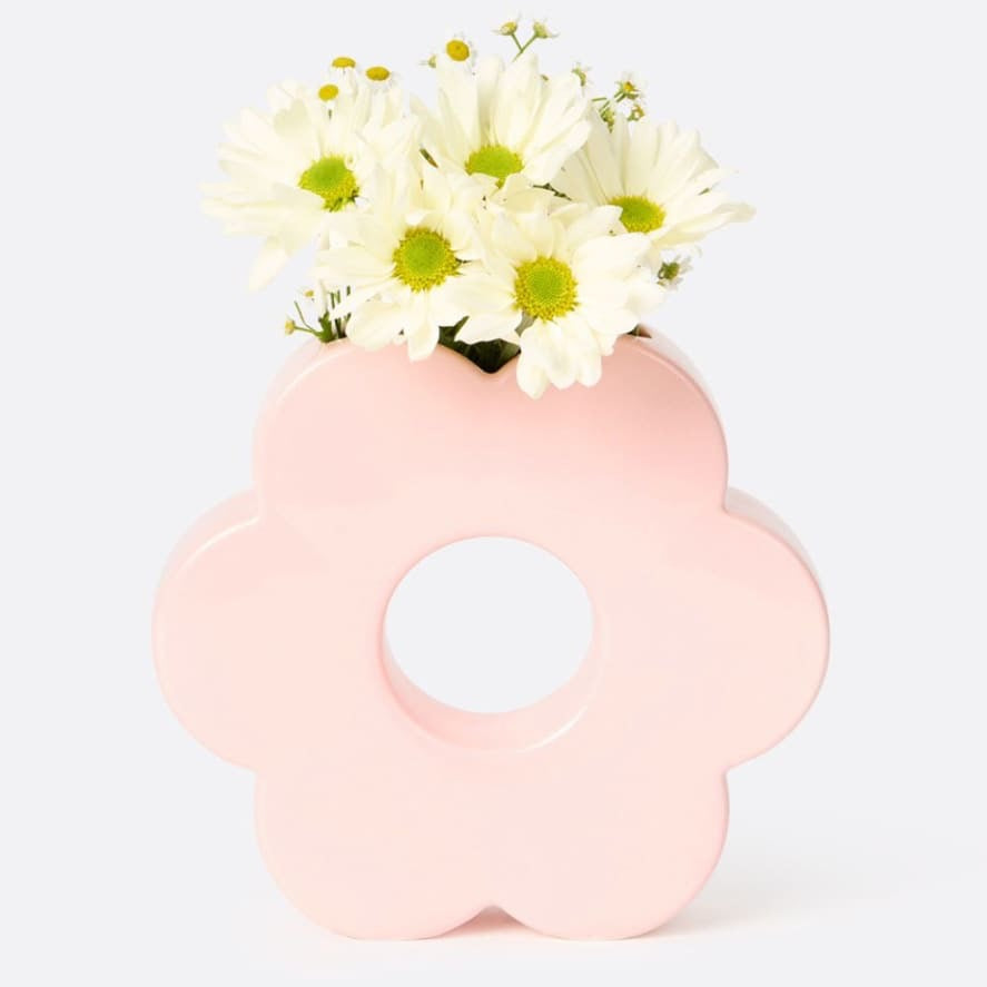 Need some pep in your decor? Add this fabulous Pink Daisy Vase to your space! Perfect for a pop of color and a hint of summer cheer, this vase will surely bring a smile to any room. A surefire pick-me-up!