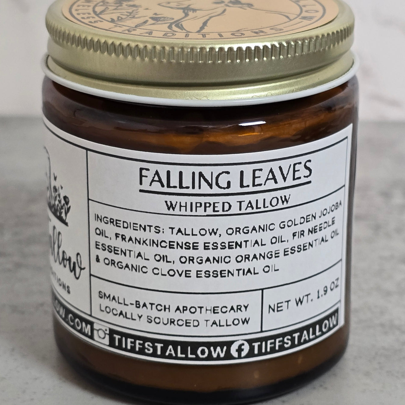 1.9oz jar of Falling Leaves Whipped Tallow against a white marble background.