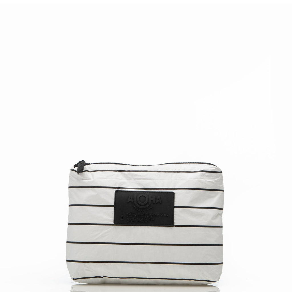 Use this small pouch in White with Black stripes as a wet bikini bag to keep your dry items separate after a swim, a surf session, or a day at the beach. This lightweight pouch will be your go-to makeup bag for travel or everyday use. It can also double as a cocktail-proof clutch to go from beach to bar or pool to pau hana.
