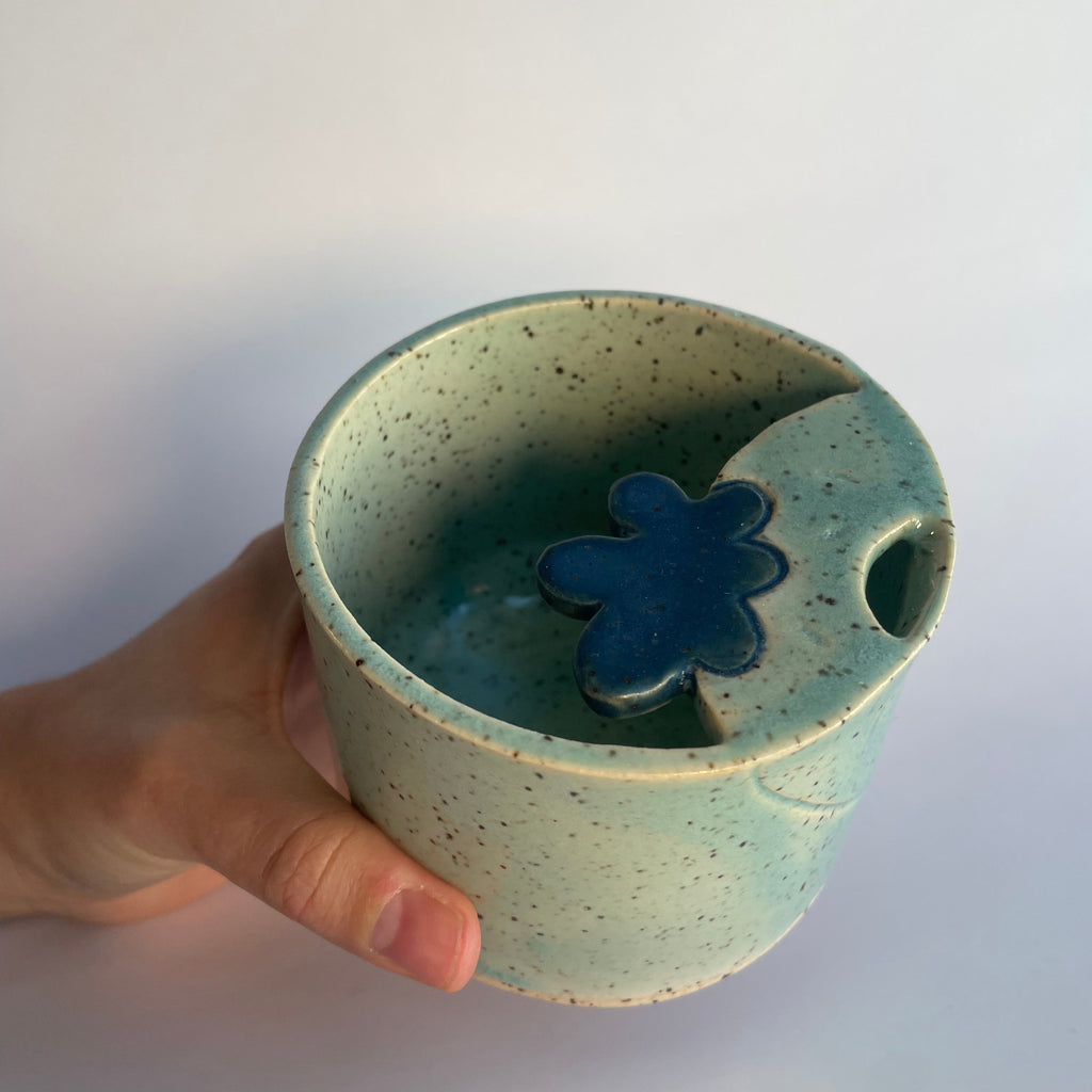 blue sipper travel cup with a blue strawberry at the top