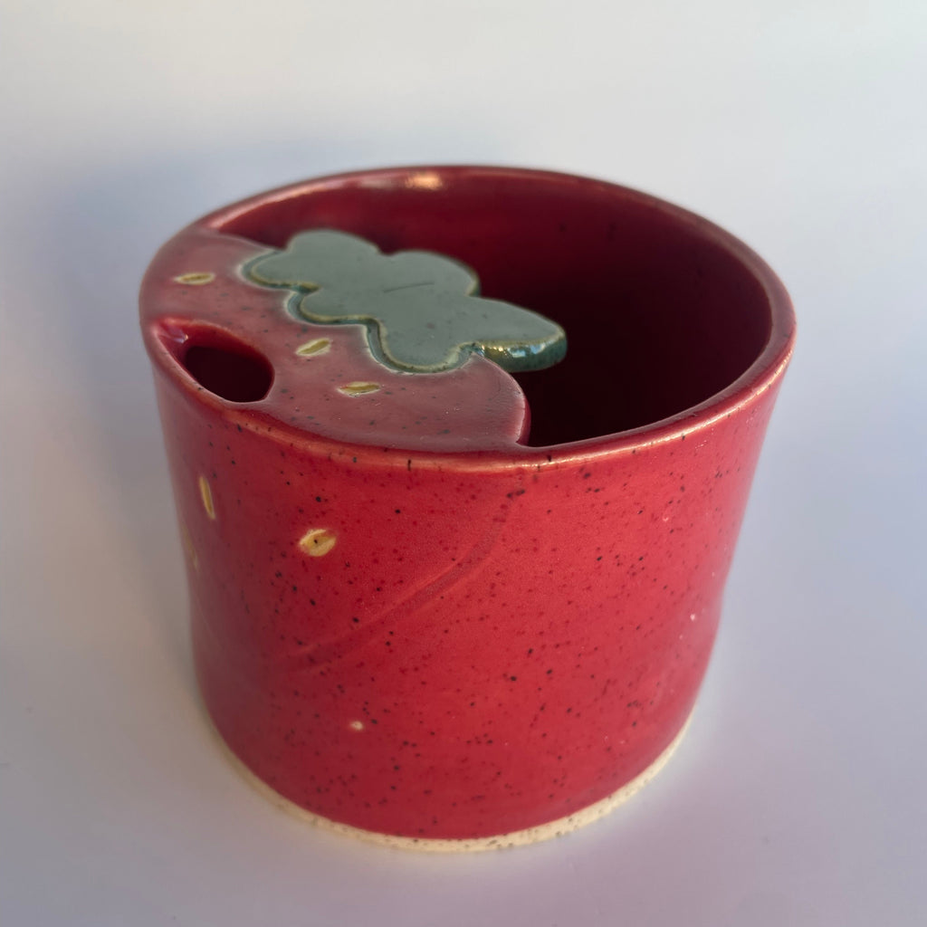 red ceramic travel cup with strawberry design
