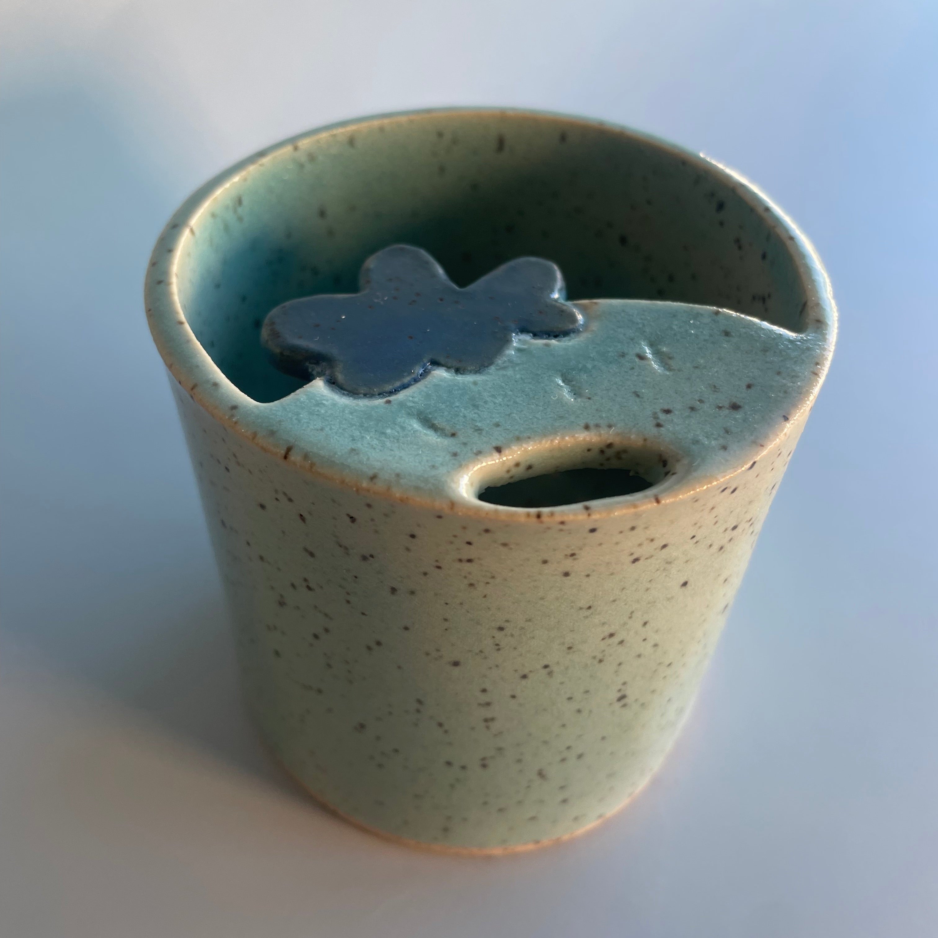 blue sipper travel cup with a blue strawberry at the top