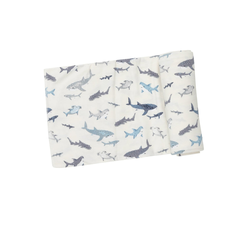 Snuggle, Swaddle, Sleep, Repeat. Our soft and adorable print swaddles are sure to delight everyone! A versatile design that's great for swaddling, nursing, cuddling and so much more. Sharks