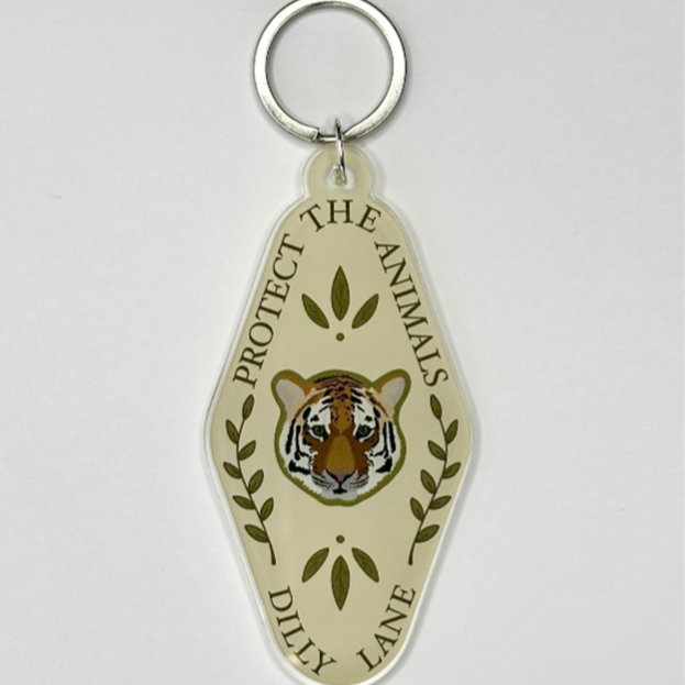 Yellow diamond shaped keychain with a tiger head reading "Protect the animals" and "Dilly Lane"