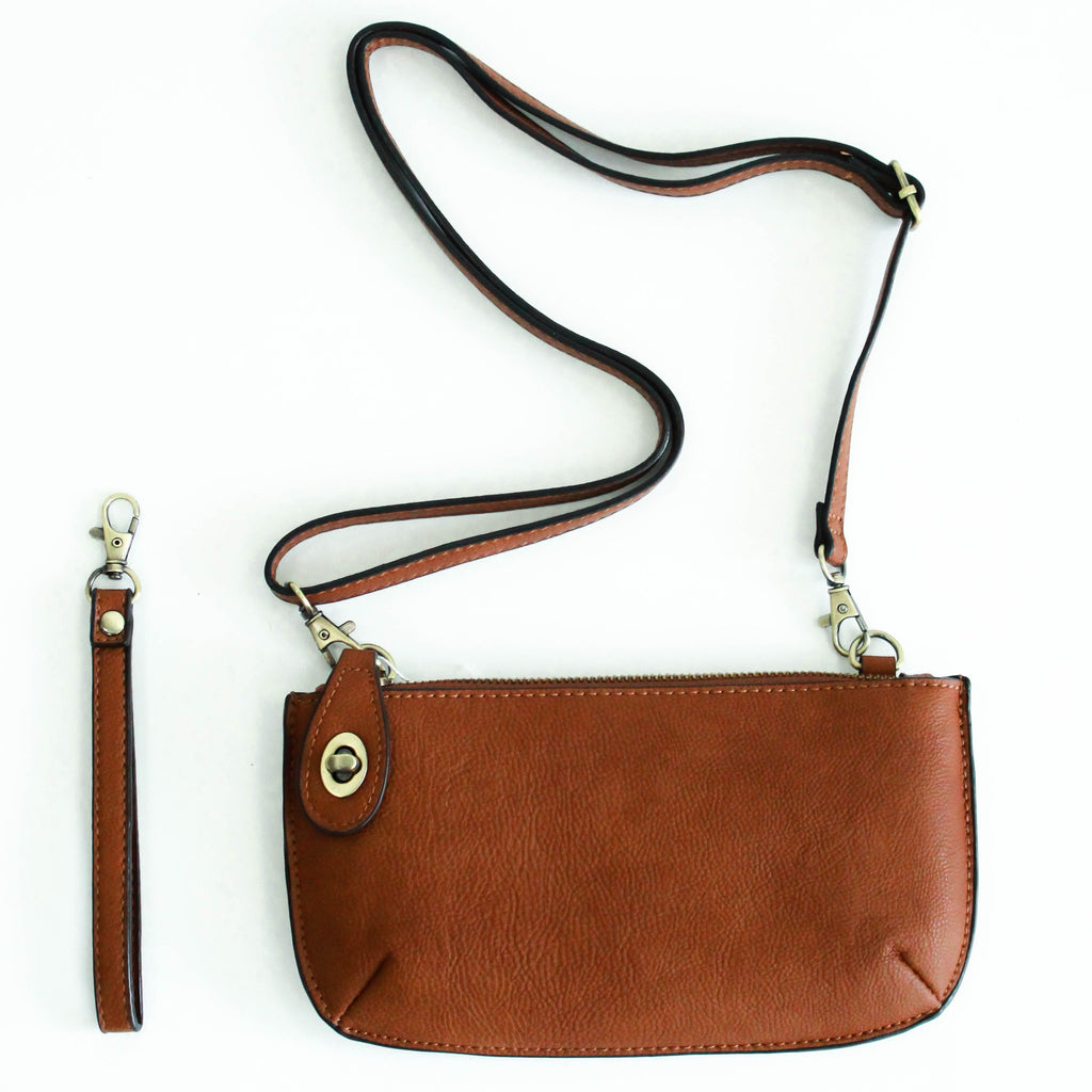 The Uptown Messenger Purse is perfection in a handbag! This versatile piece can be used as an adjustable cross-body bag, wristlet, or a simple wallet, making it the perfect finishing touch to any night out. A zippered top and rotating clasp closure are timeless elements that will make this the most functional purse you'll ever own!