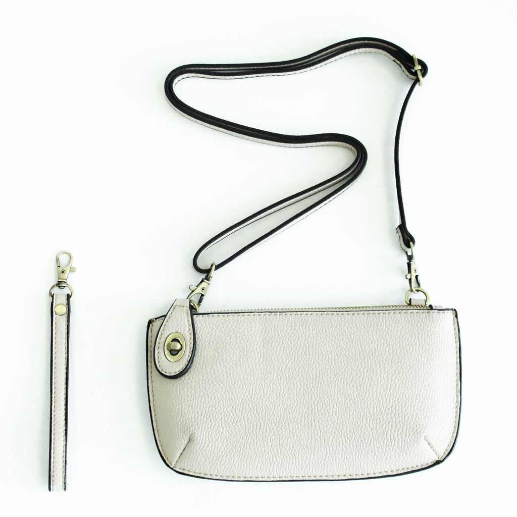 The Uptown Messenger Purse is perfection in a handbag! This versatile piece can be used as an adjustable cross-body bag, wristlet, or a simple wallet, making it the perfect finishing touch to any night out. A zippered top and rotating clasp closure are timeless elements that will make this the most functional purse you'll ever own!