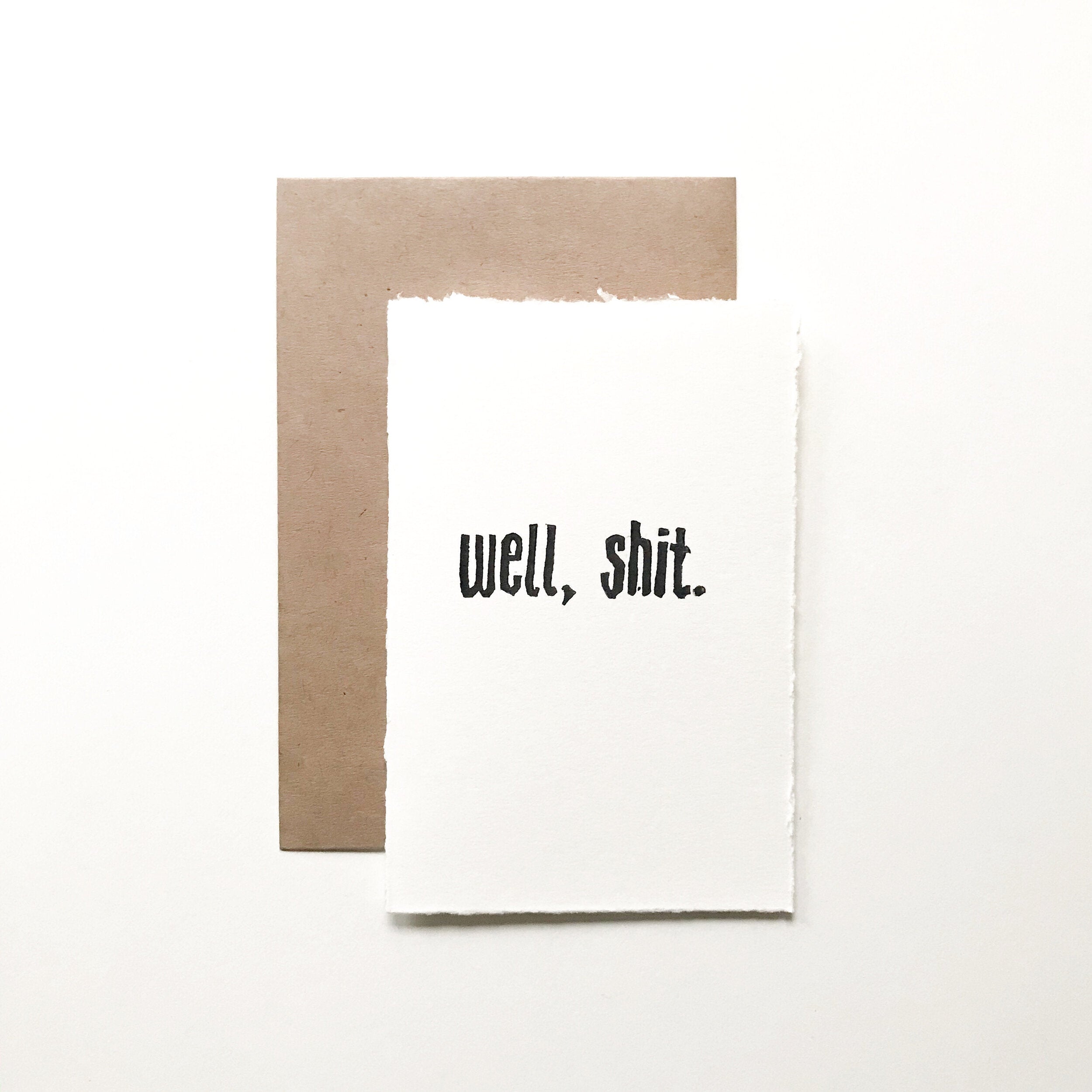 4x6 hand carved and pressed card reading "well, shit."