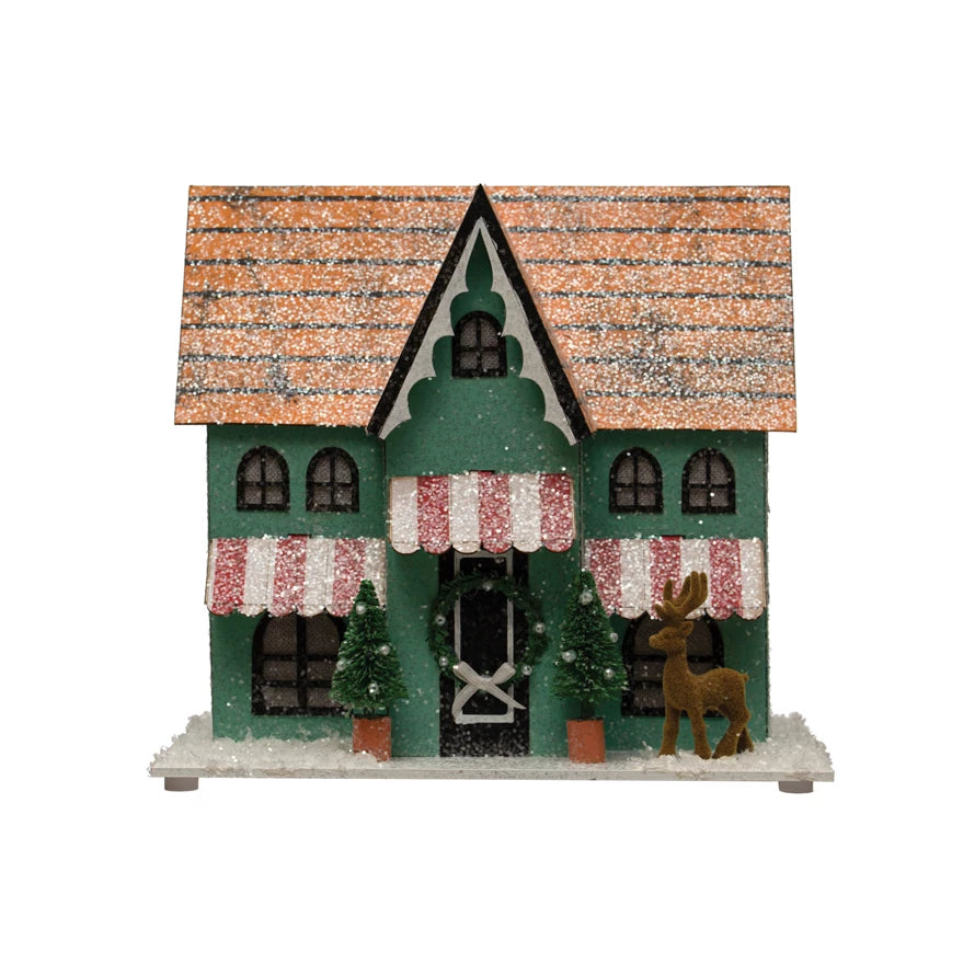Light up your world in festive holiday style with this paper house! It's decorated with glitter, trees, deer, and an LED light – it's all you need for a sparkling winter wonderland. Get ready for beaucoup compliments when your guests set eyes on this multi-colored masterpiece. (Requires 6 AAA batteries – not included.)     Dimensions  10"L x 7"W x 6"H