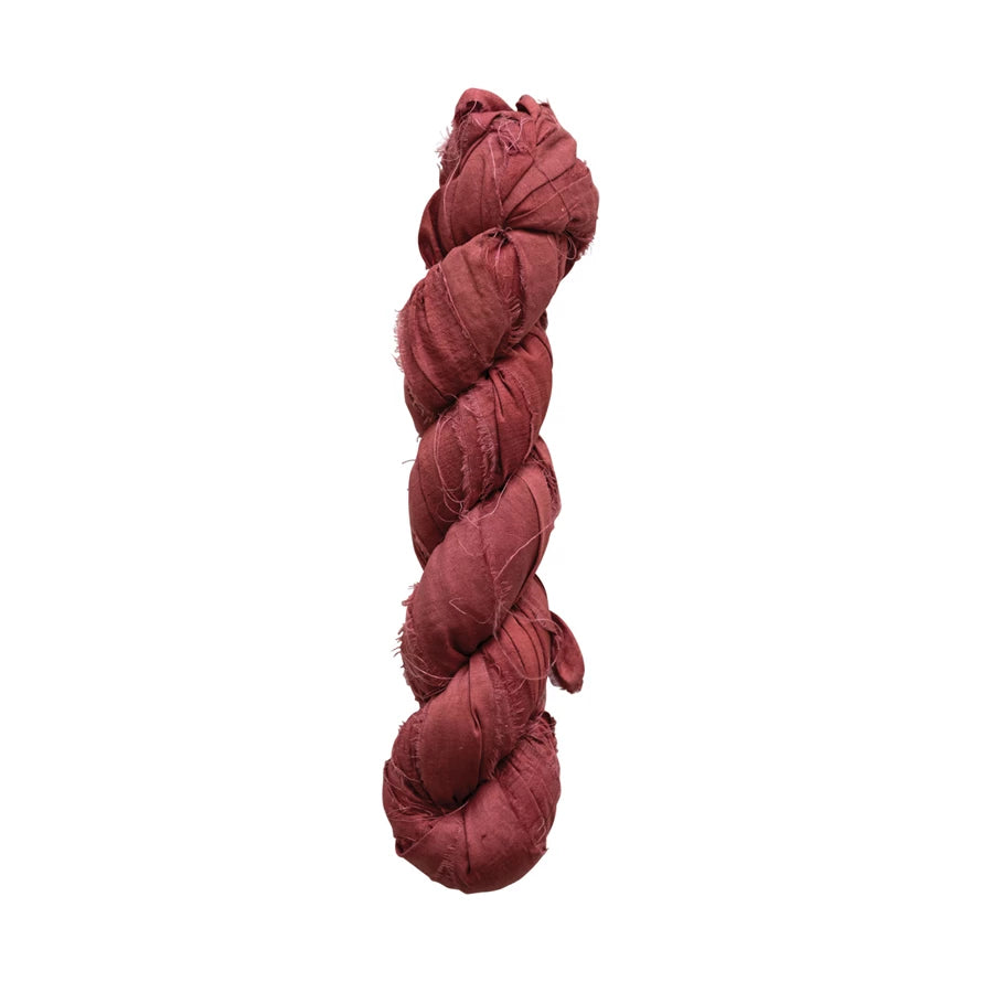Going green never felt so glamorous! Get creative with this fancy recycled torn silk ribbon, available in chic Redish Brown. Perfect for adding a touch of rustic elegance to your special occasion projects. (And no need to feel guilty about it!) 70-75 yards of eco-friendly chicness, coming right up!     Color  Redish Brown     Material  Recycled Torn Silk Ribbon     Size  70-75 Yard