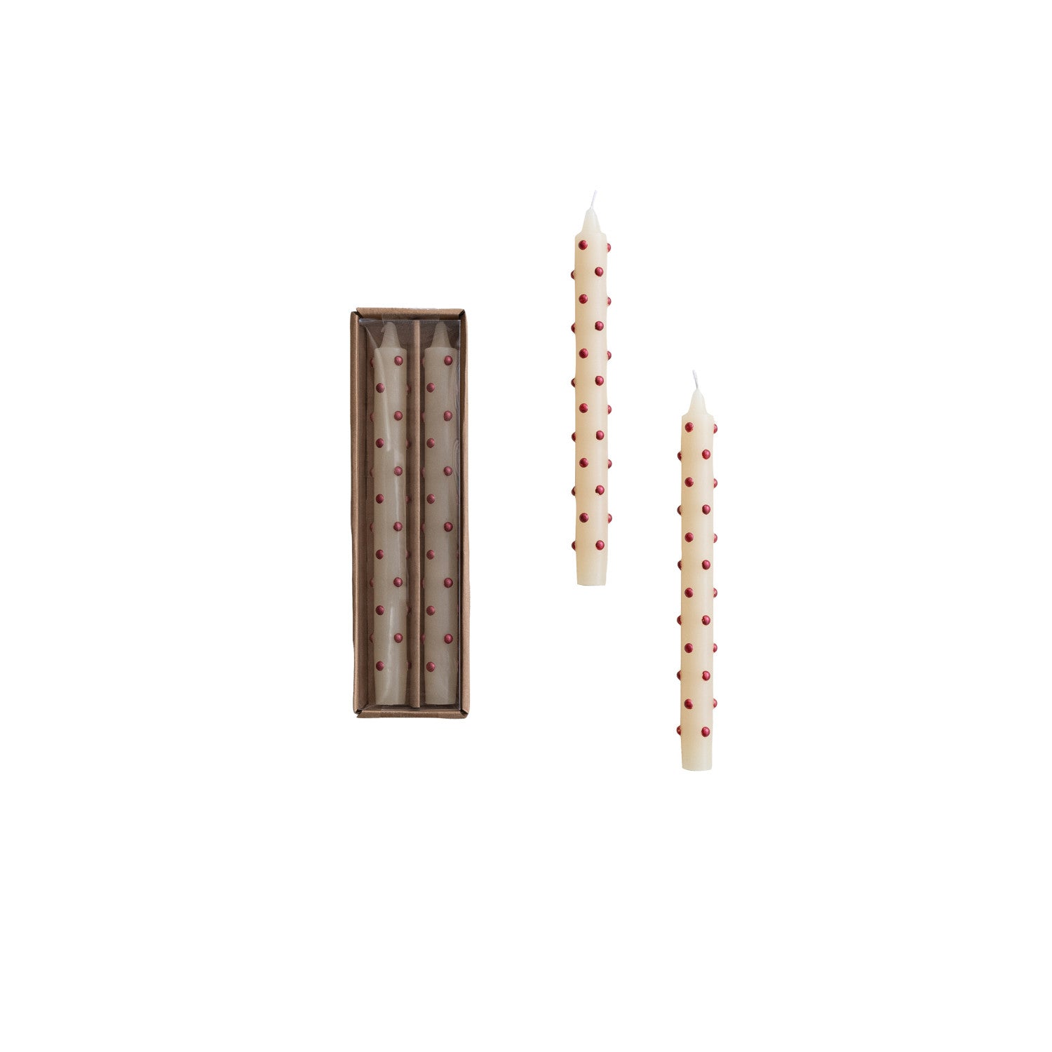 Two tall, thin candles with red dot patterns next to their packaging on a white background