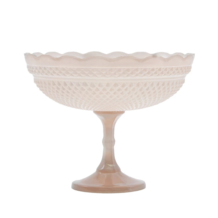 Pink textured pedestal bowl on a white background