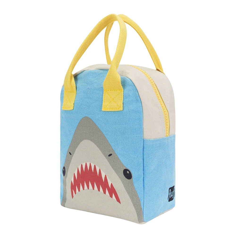 Certified organic cotton. Preshrunk and fully machine washable. Cotton canvas carry handles. Zipper closure. Rinse-able, tested food-safe lining. Interior pocket (for a water bottle or ice pack). Durable and roomy. Lunch bag is lined but not insulated. Water-resistant lining works well with an ice pack, if desired. Shark pattern.