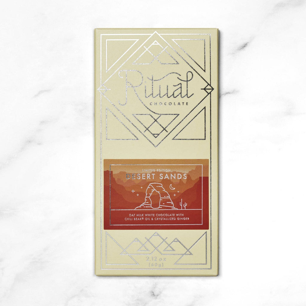 Desert Sands - 30% Cacao- This bar's flavors and textures were inspired by the high mountain deserts of Southern Utah. Ritual added local Utah Chili Beak oil to our first oat milk white chocolate, sprinkled in crystalized ginger, to make a beautiful sandstone colored chocolate with a kick of summer heat.