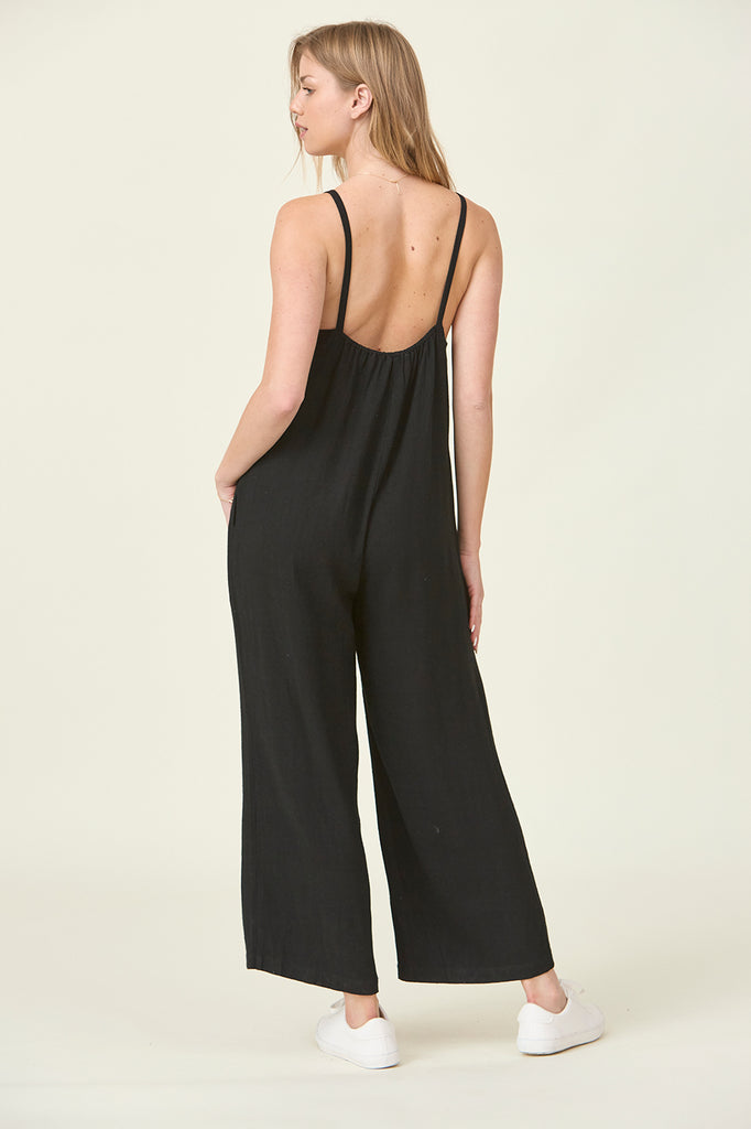 Black wide leg overall with buttons ups front. Slides over hips