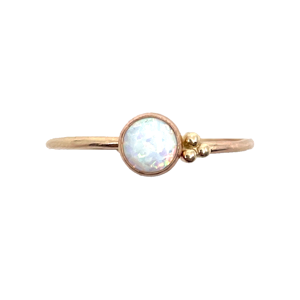 A trio of delicate dots nestles up next to a shimmery opal stone in this ring.   Hand-formed, this ring is set in a bezel style in 14k goldfill.  Available in sizes 4-11 16 Gauge wire thickness 6mm opal and 2 mm round dots Polished finish