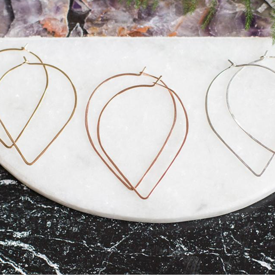 It's a different take on a hoop. Slightly oversized earring with a curved top and pointed base hangs 2” in total. Built-in closure will keep this piece in place.