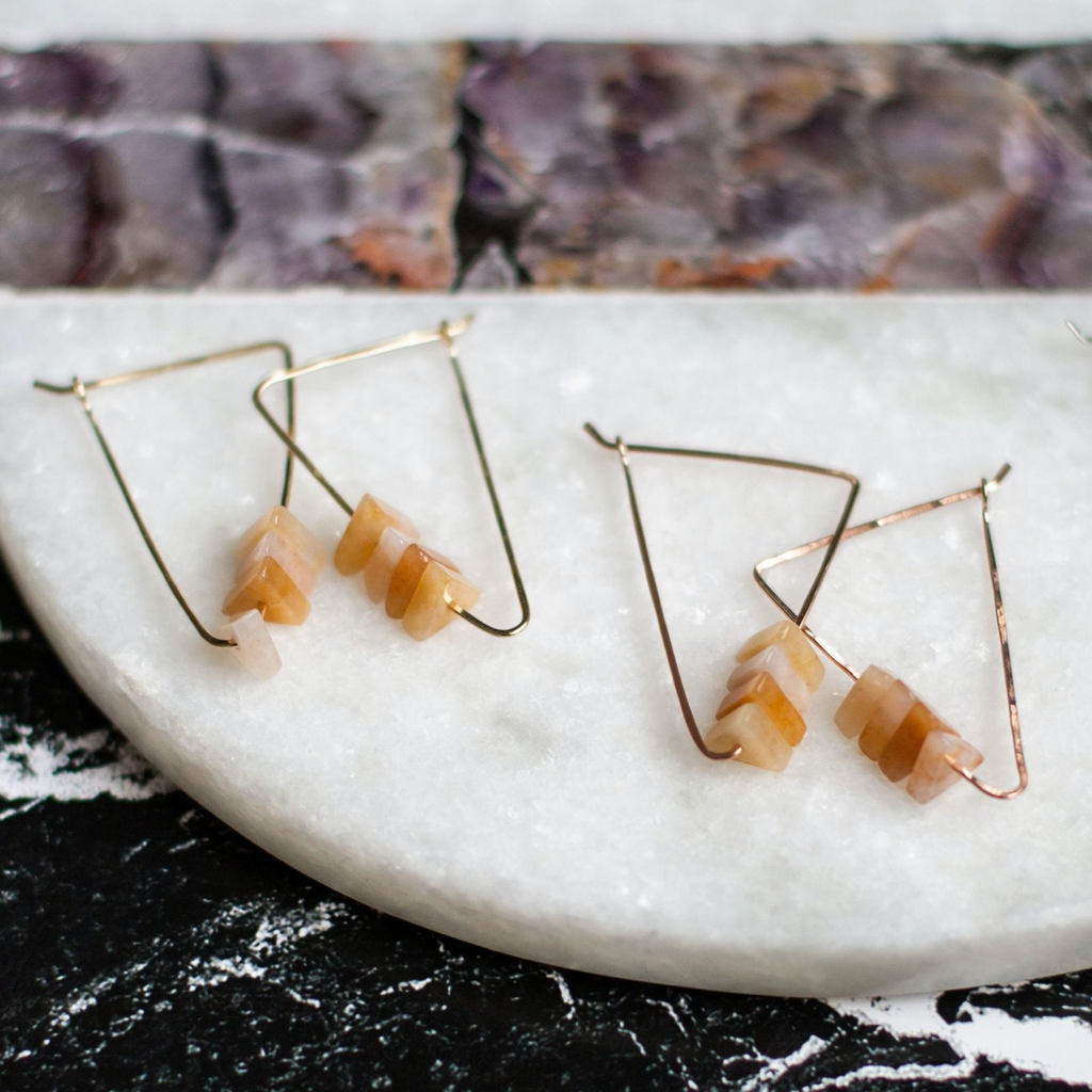 elongated, self-closing triangle hoop adorned with 4 yellow agate triangle shaped beads.