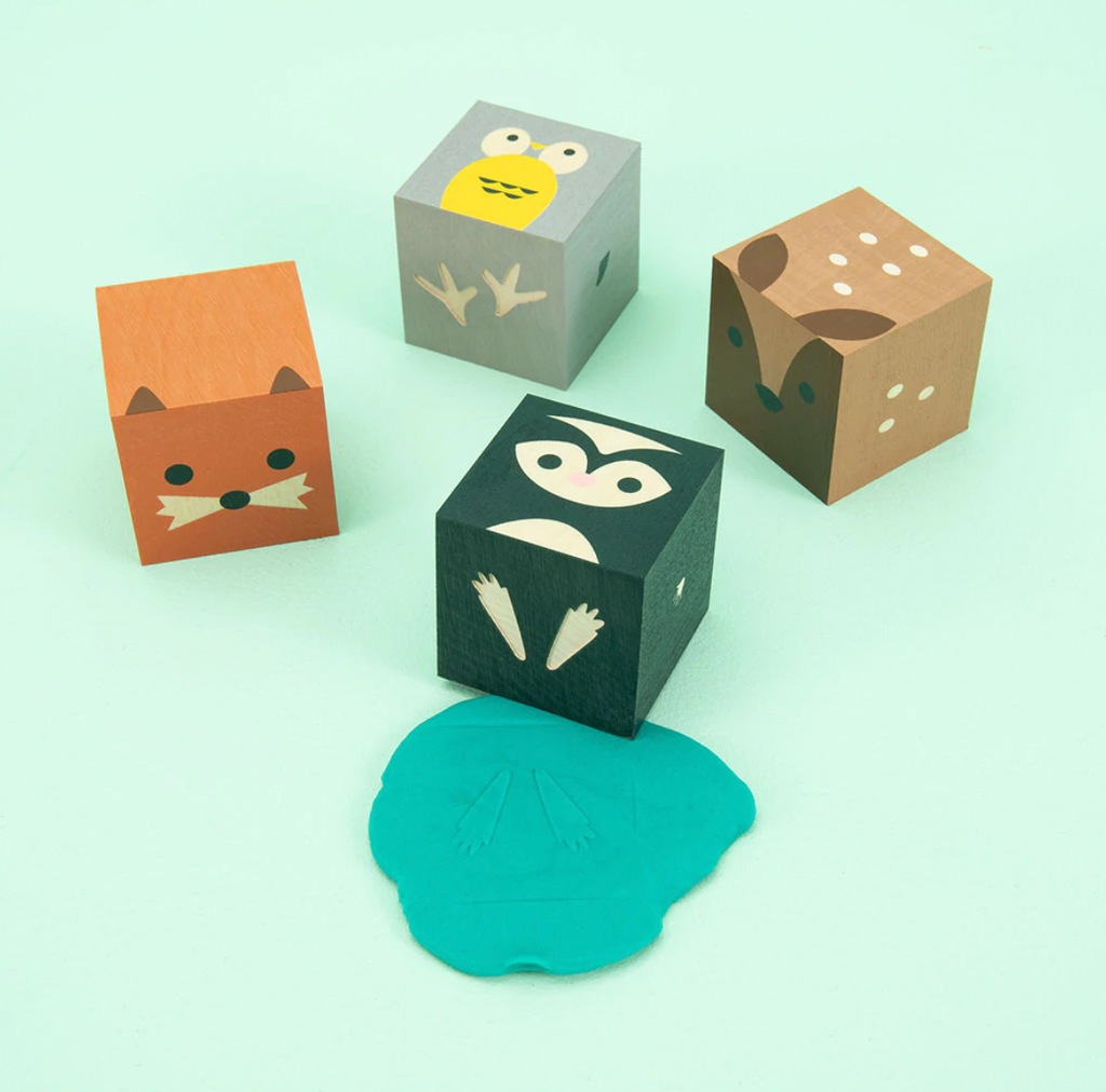 Owl. Skunk. Deer. Fox. Your favorite forest animals, squared.  Made from sustainable Midwestern basswood. You’ll also find four paper environments. Eco-friendly fun.  Mix, match, hoot.  4 - 1.75 inch cubes