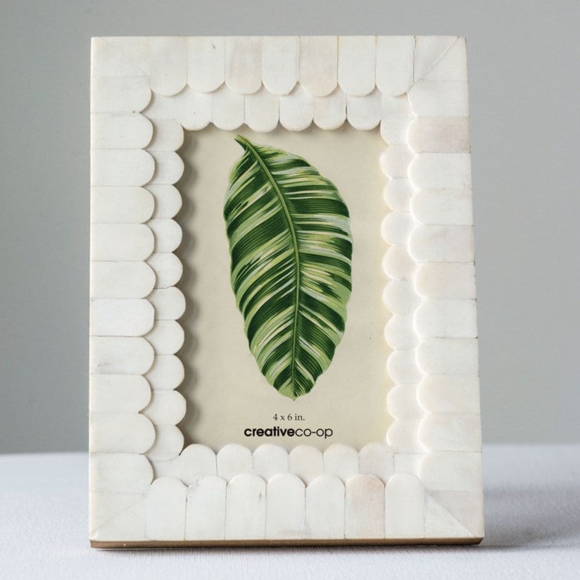Frame your memories in style with our MDF &amp; Bone Photo Frame. Made with durable MDF and bone, this frame adds a touch of elegance to any room. Perfect for showcasing your favorite photos and adding a unique touch to your decor. Memories never looked so good!"