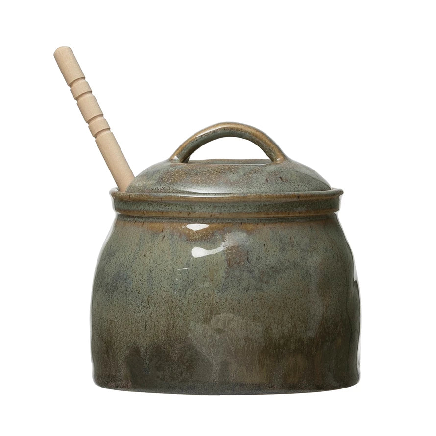 This honey jar is an adorable addition to any home. Made out of stoneware, this jar features a unique blue and green reactive glaze finish. It also comes with a wooden honey dipper, perfect for getting the honey. This piece also looks great set out on counters as a display piece.