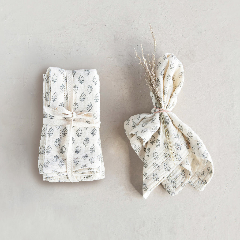 These napkins are made out of cotton, and have a beautiful charcoal and cream floral pattern.       Size  18" Square Cotton Napkin