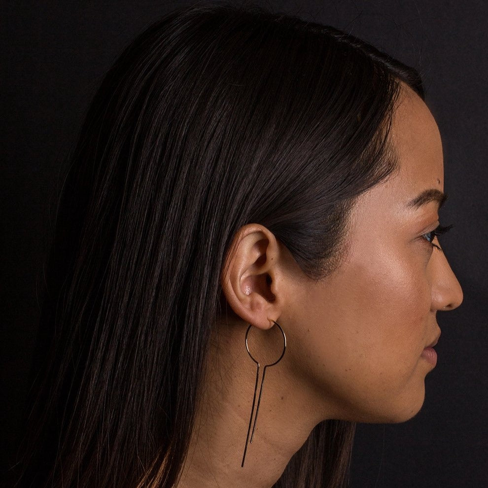 it starts out as a hoop and gets a bit more unusual. this long, dripping earring can be worn with either the short or long side facing out, whichever is your fancy.