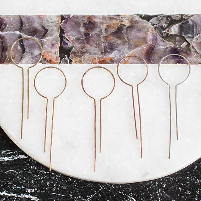 it starts out as a hoop and gets a bit more unusual. this long, dripping earring can be worn with either the short or long side facing out, whichever is your fancy.