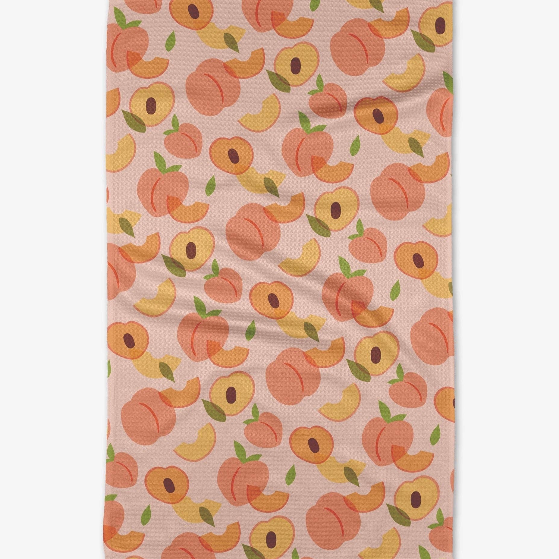 A microfiber tea towel with a single-sided print featuring a repeated pattern of peaches in various shades of orange and yellow on a beige background.